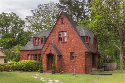 green metal roof on red brick house|black shingles on brick house.